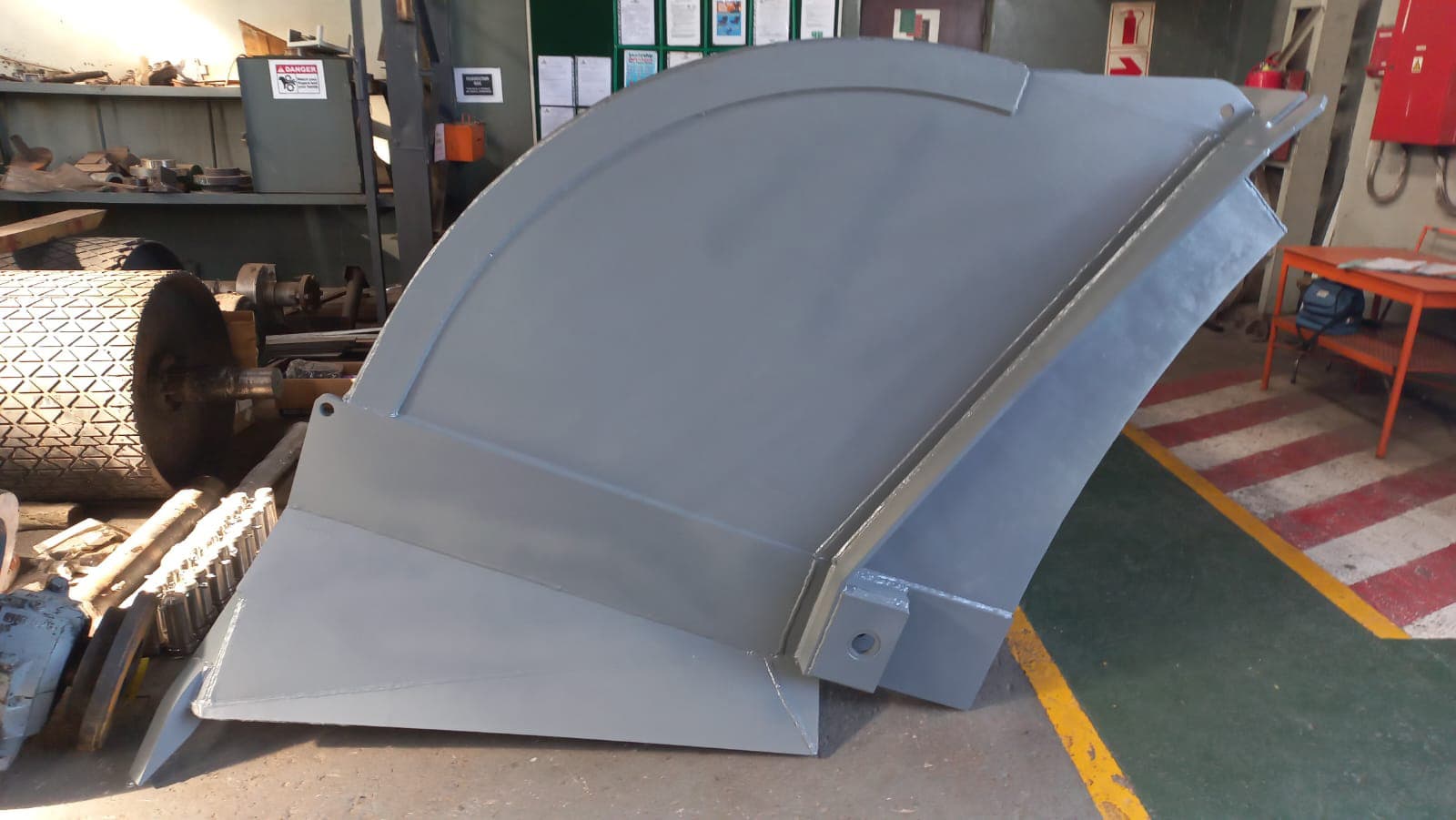 Large fabricated steel bucket or chute assembly in the workshop