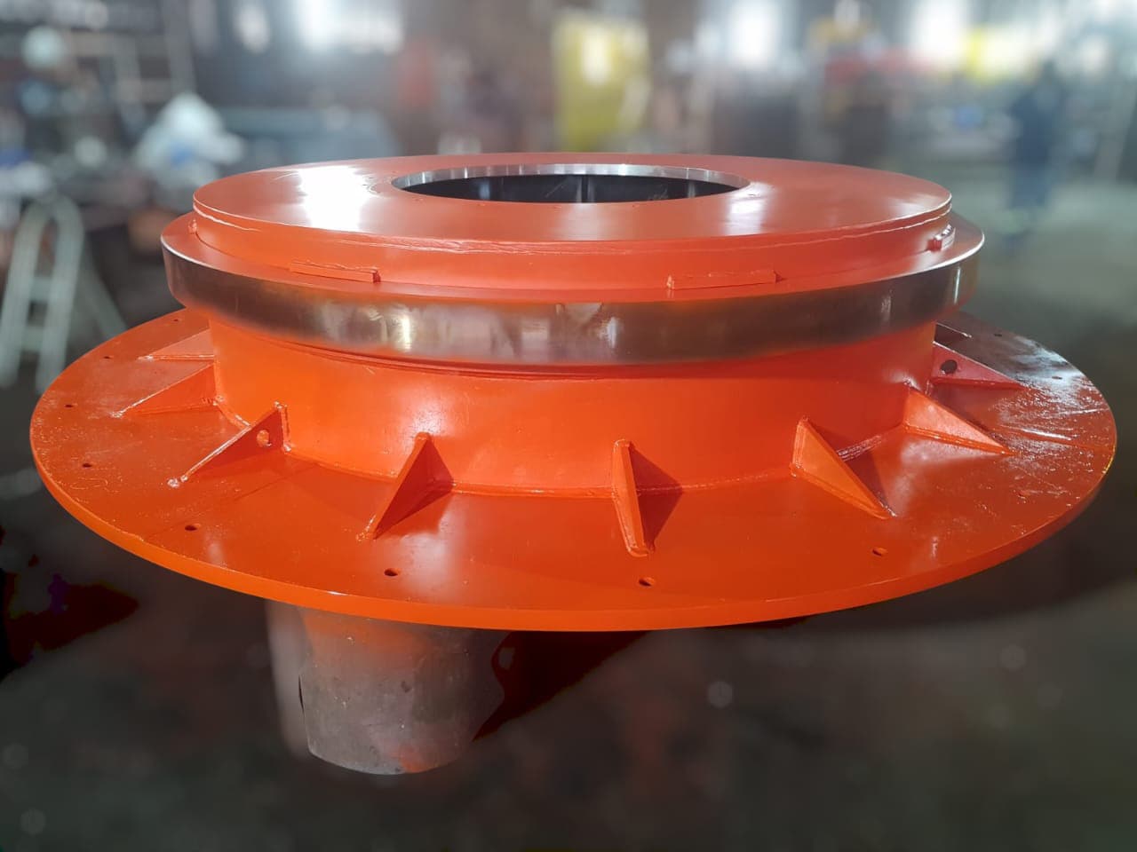 Orange circular fabricated component with machined centre ring